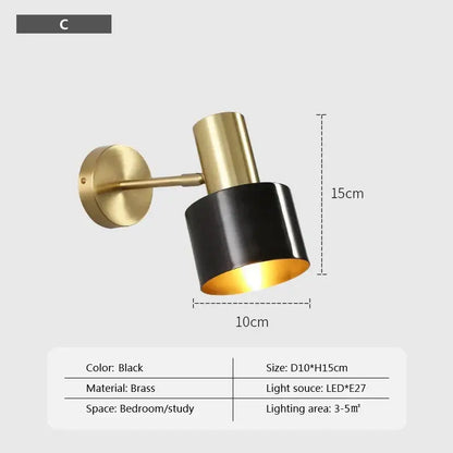 Minimalist brass and black iron wall lamp with black cylindrical shade and gold-toned arm for modern bedroom lighting