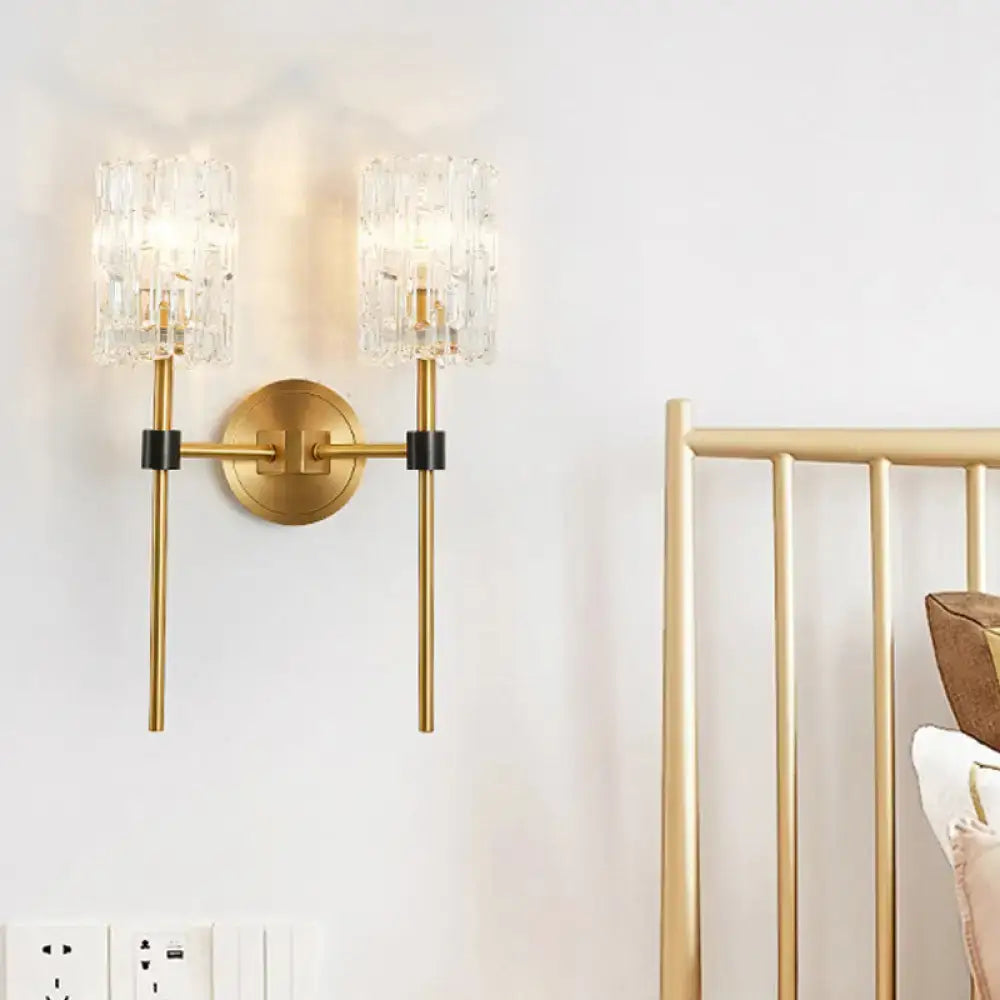 Minimalist brass crystal cylindrical wall sconce with gold tone and black accents for living room lighting