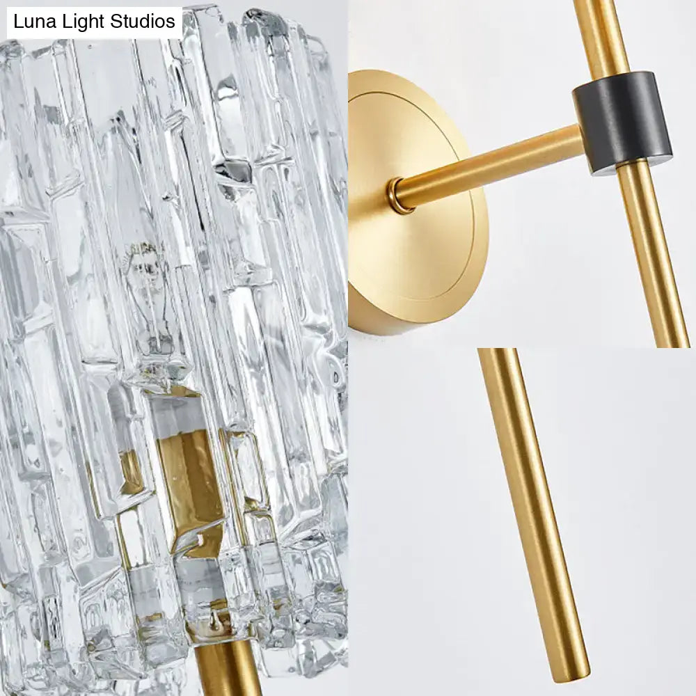 Minimalist brass crystal cylindrical wall sconce with clear faceted glass and gold metal frame for living room lighting