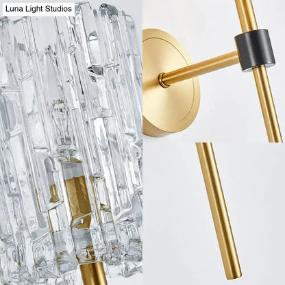 Minimalist brass crystal cylindrical wall sconce with clear faceted glass and gold metal frame for living room lighting