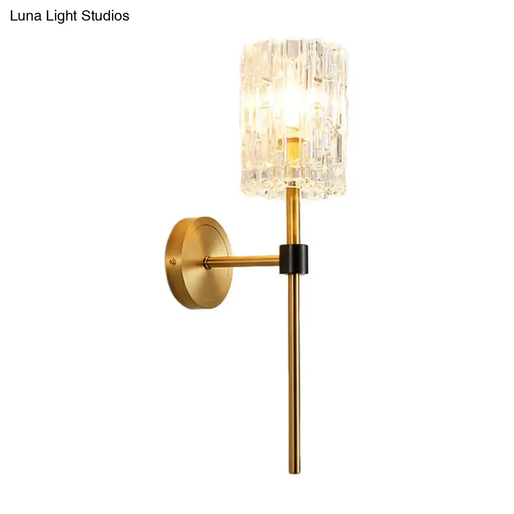Minimalist brass crystal cylindrical wall sconce with gold metal base and glass shade for living room lighting