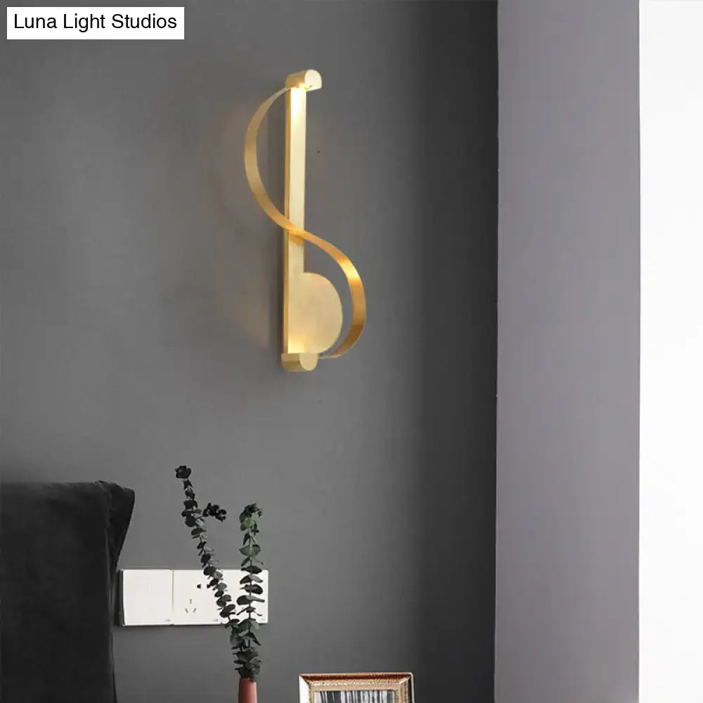 Minimalist gold brass curve led wall mount light with sleek curved design resembling a musical note for living room