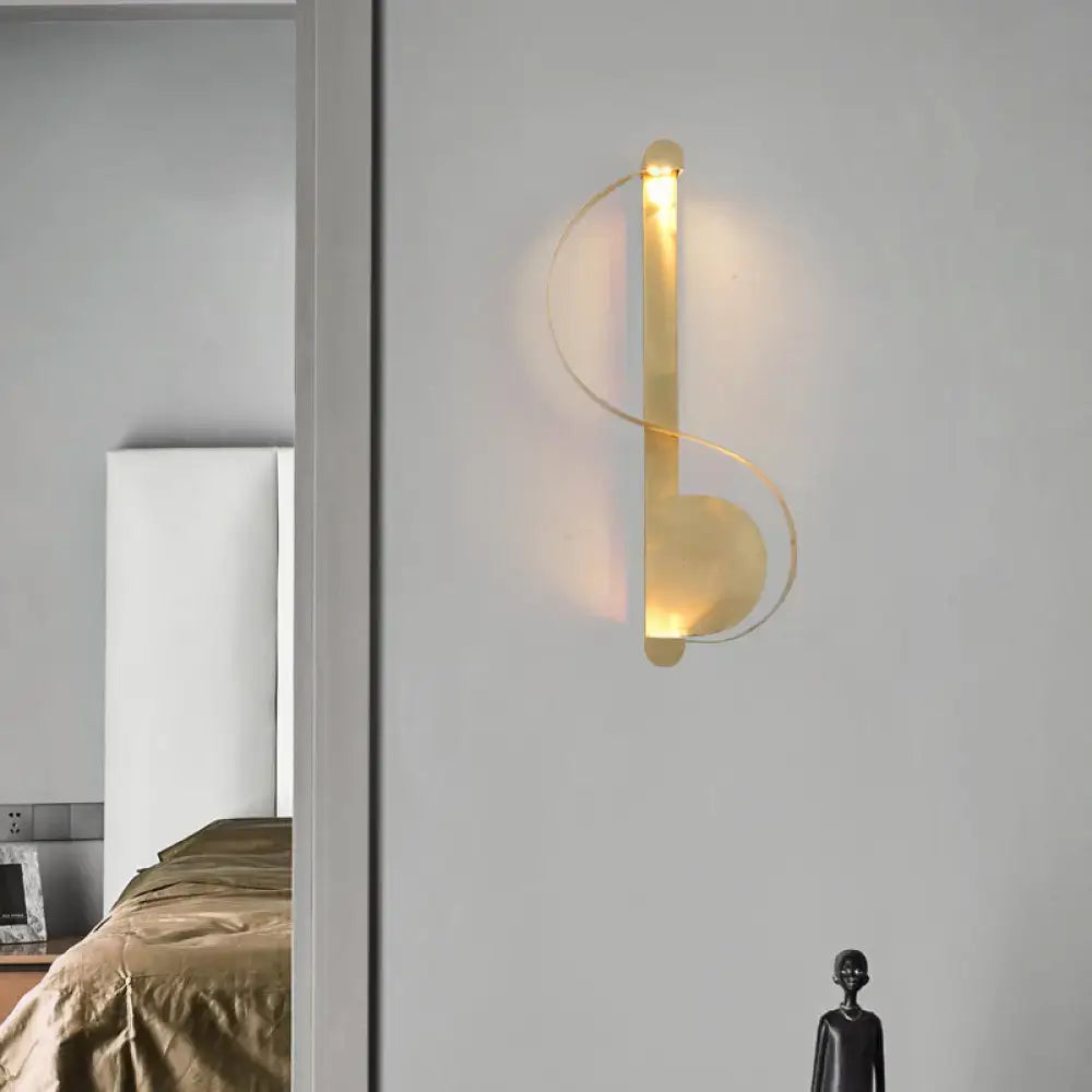 Minimalist brass curve led wall mount light in gold tone with sleek curved design and warm ambient lighting for living room