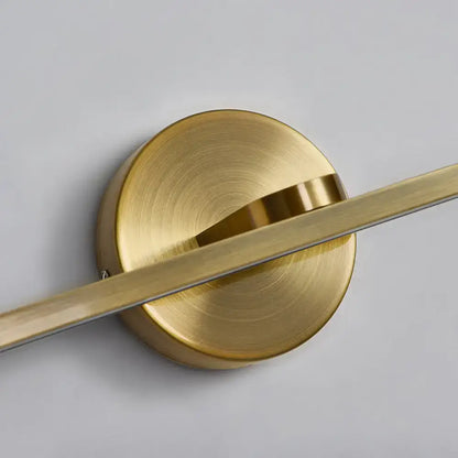 Minimalist brass elliptical wall light with brass finish and sleek circular base for modern bathroom sconce fixture