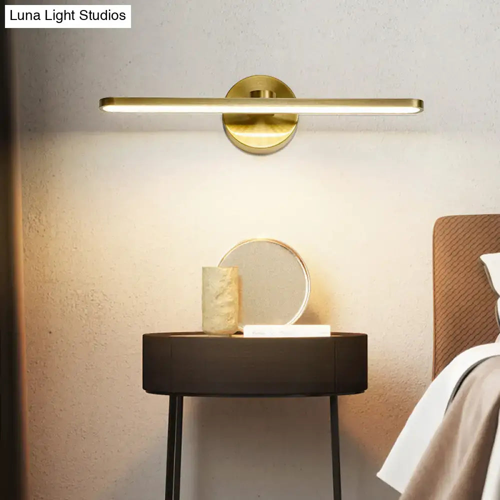 Minimalist brass elliptical wall light with gold-toned rectangular led fixture and circular base for bathroom sconce