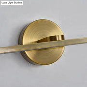 Minimalist brass elliptical wall light with brass finish and sleek design for bathroom sconce fixture