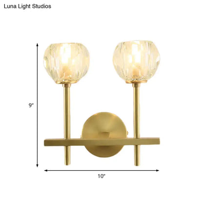Minimalist brass faceted crystal wall sconce with two direct wired faceted crystal globe shades and geometric base