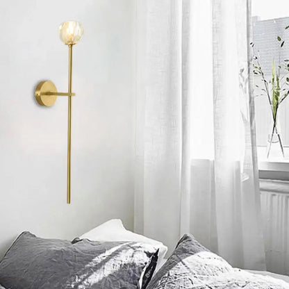 Minimalist brass faceted crystal wall sconce with gold tone direct wired slender stem and frosted glass globe in two sizes