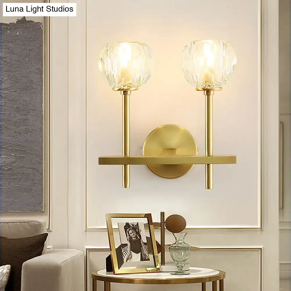 Minimalist brass wall sconce with gold tone and two faceted crystal shades in two sizes direct wired for bedroom lighting