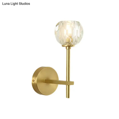 Gold-toned minimalist brass faceted crystal wall sconce with globe shade direct wired available in two sizes