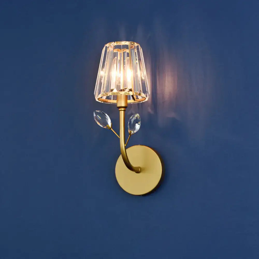 Minimalist gold-toned brass finish wall sconce with faceted crystal shade and two clear dangling crystals wall light