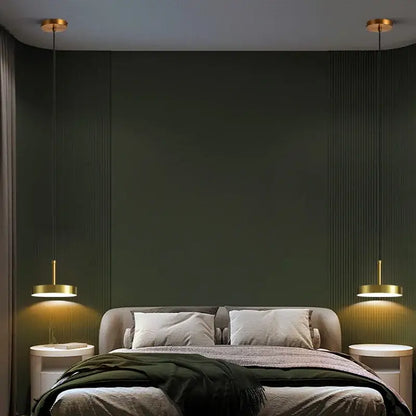 Gold-toned minimalist brass led pendant lights from decorbites hang symmetrically above the bed in a dining room setting