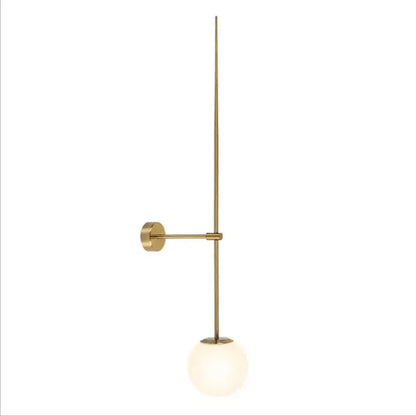 Minimalist brass led wall light with slender vertical rod and frosted glass globe shade for bedroom use