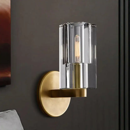 Minimalist brass wall sconce with bulb base features vertically ribbed glass shade for living room lighting type