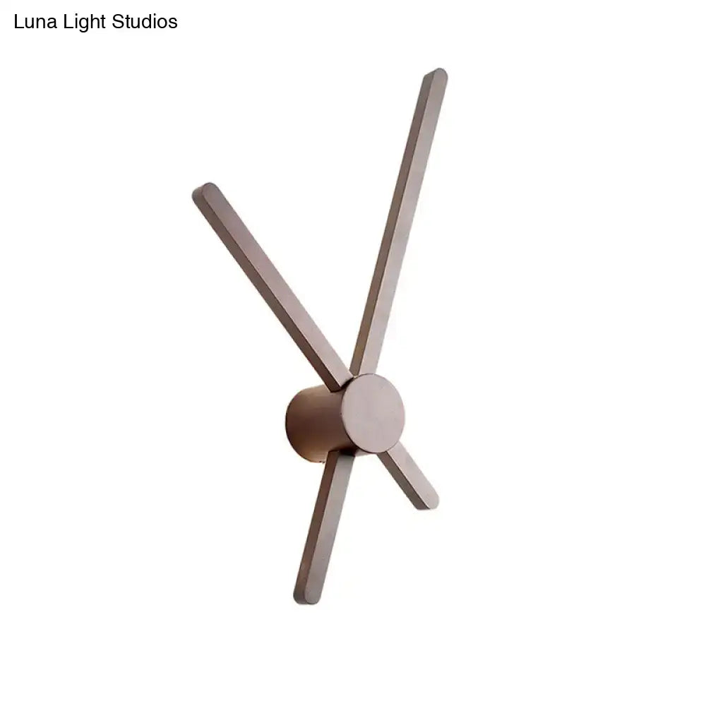 Minimalist brass wall light sconce featuring a wall clock with slender matte-finished brass arms and circular hub