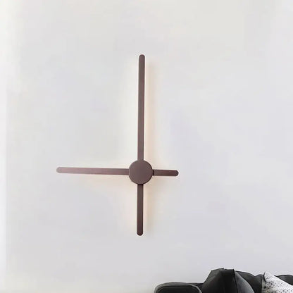 Minimalist sconce wall light with sleek matte bronze arms and a circular base for living room clock lighting