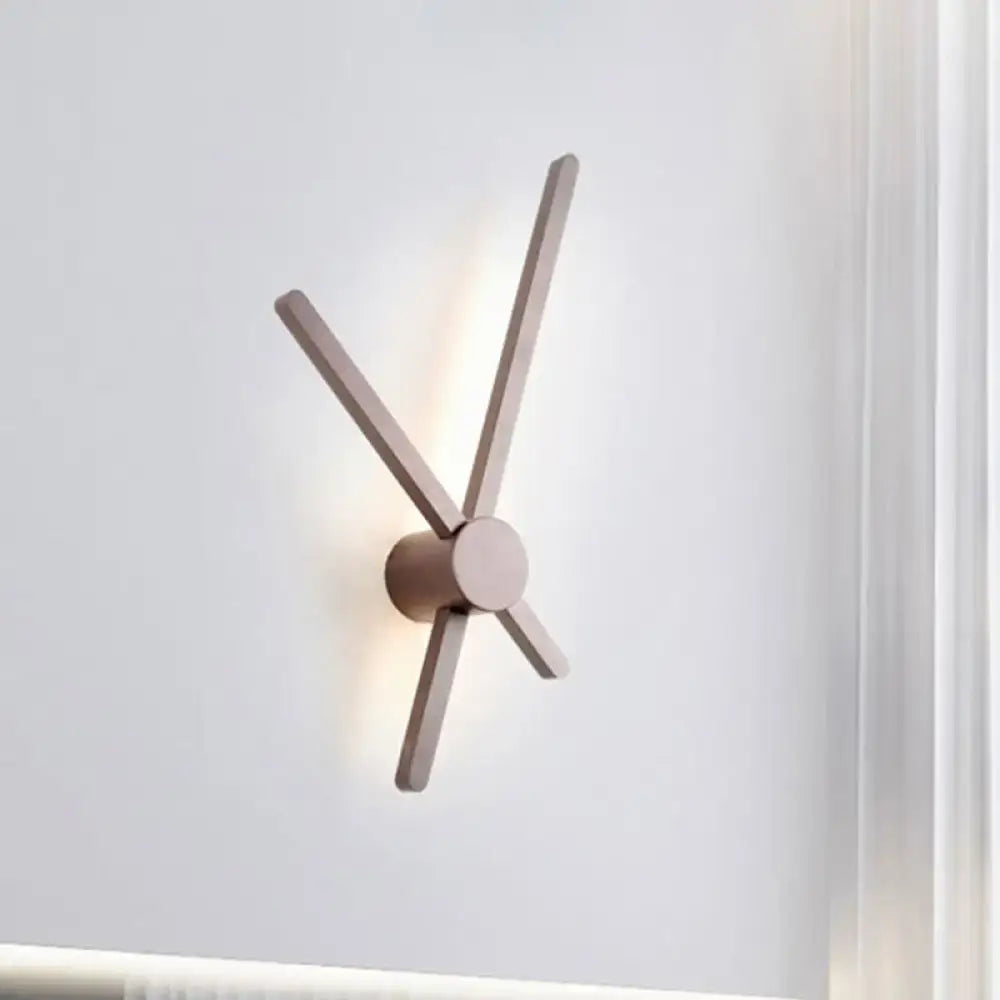 Minimalist brass sconce wall light with four slender matte wooden arms radiating from a central cylindrical base