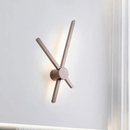 Minimalist brass sconce wall light with four slender matte wooden arms radiating from a central cylindrical base