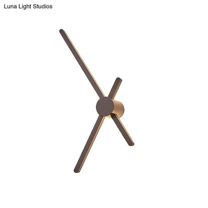 Minimalist brass sconce wall light with slender matte bronze arms and cylindrical base for living room clock lighting
