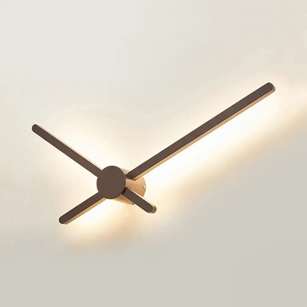 Minimalist brass sconce wall light with dark wooden arms and circular base for living room clock lighting