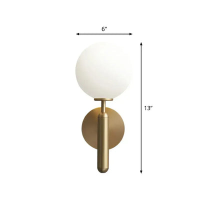 A minimalist brass wall sconce with a cream glass shade designed for elegant living room lighting