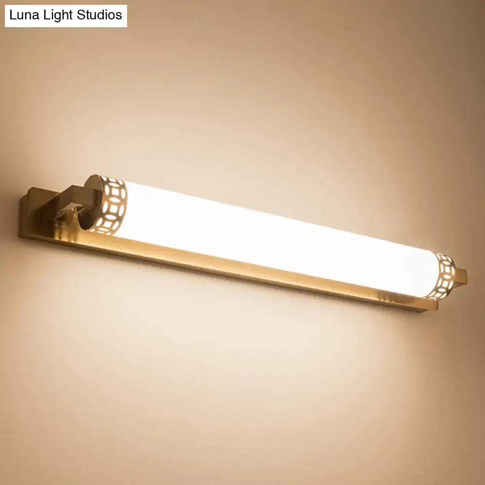 Minimalist bronze wall light sconce with gold-toned finish, frosted glass diffuser, and decorative lattice end caps for bathroom vanity
