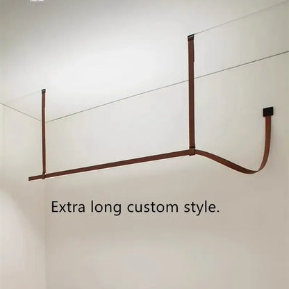 Minimalist brown leather hanging clothes drying rack with sleek rod design for bedroom decor and pendant light accents