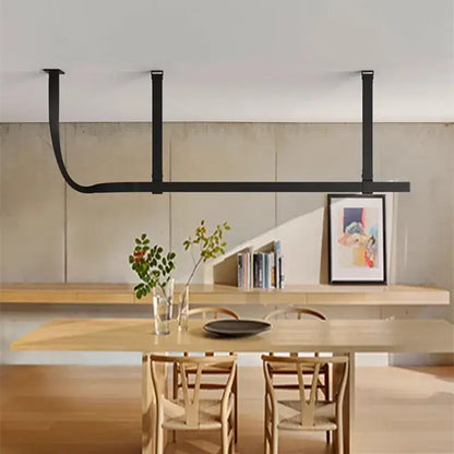 Black metal pendant lamp with minimalist design suspended above wooden table complements decorbites belt decor