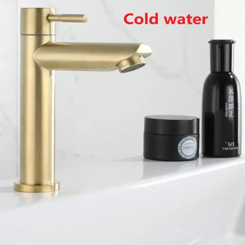 Minimalist brushed gold stainless steel single hole bathroom faucet with gold-toned single handle and sleek modern design