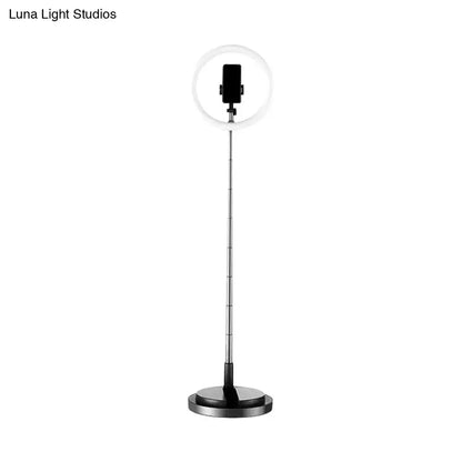 A sleek minimalist circular metal mobile phone vanity ring light with black smartphone mount for 110v-120v use