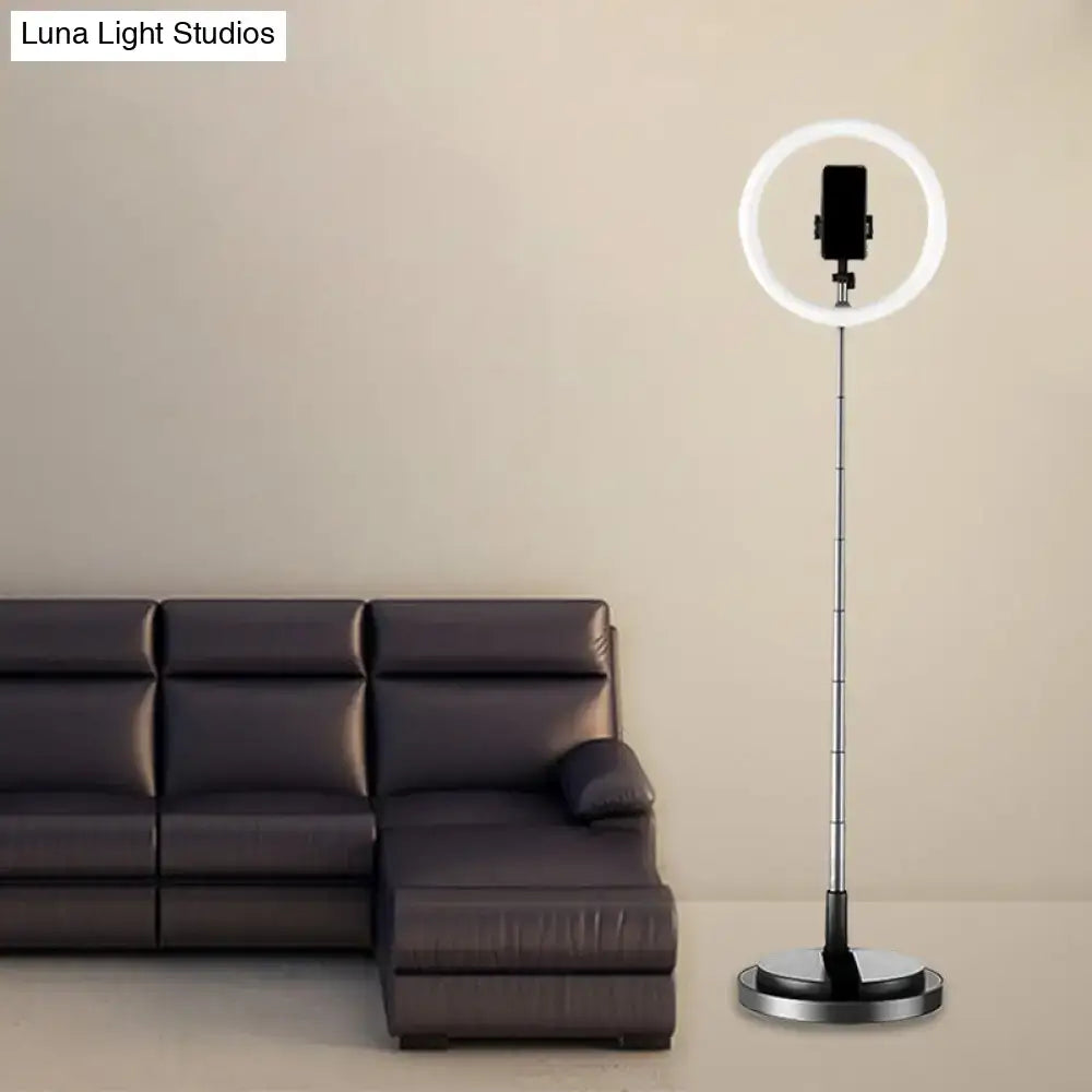 A minimalist circular metal mobile phone vanity light with a slim stand in 110v-120v for bedroom use