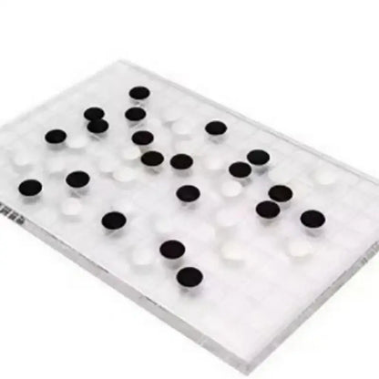 Minimalist clear geometric chess set with acrylic board and black and white stones for modern decorbites geometric chess decor