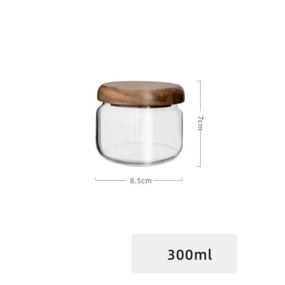 Minimalist clear glass storage jar with smooth rounded acacia wood lid for kitchen organization