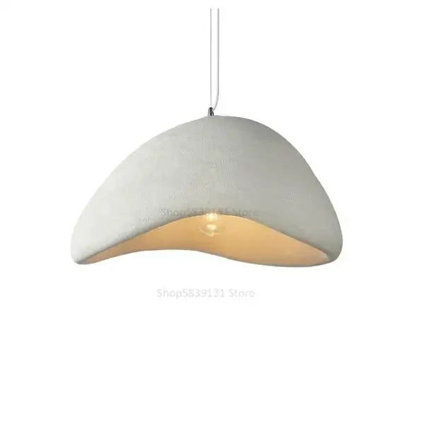 A modern off-white concrete dome pendant light with an exposed warm bulb, ideal as decorbites cobblestone pendant lights