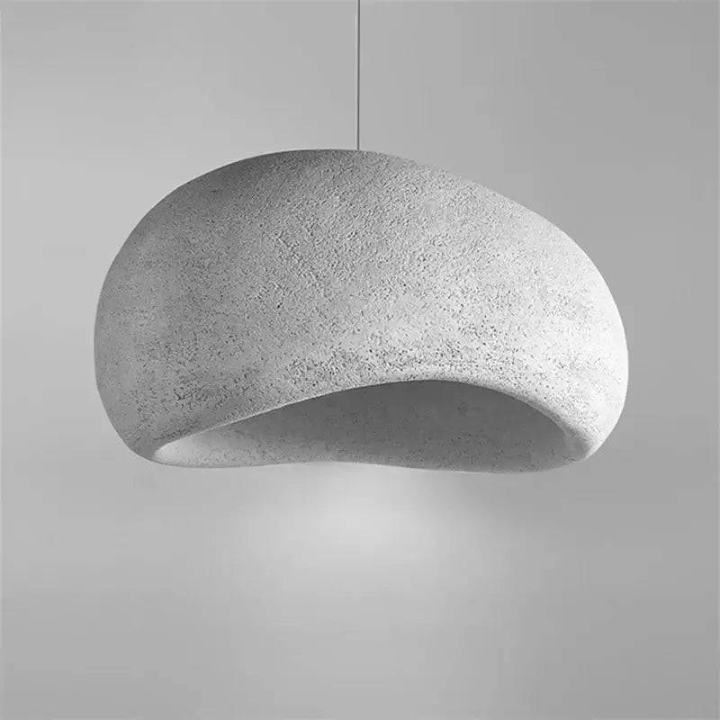 Minimalist concrete cobblestone pendant light with smooth organic dome shape and textured surface for dining room decorbites pendant lights