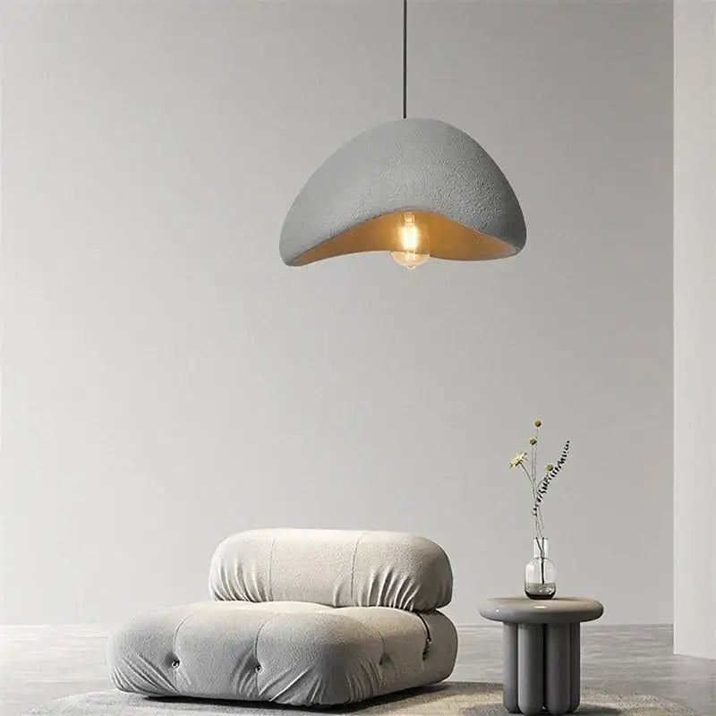Gray textured decorbites cobblestone pendant light with warm interior and exposed bulb for minimalist dining room decor