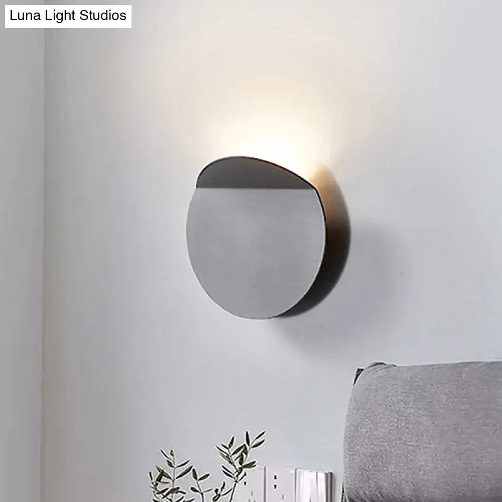 Minimalist copper wall mount sconce light with sleek circular design and matte black finish featuring led bulb
