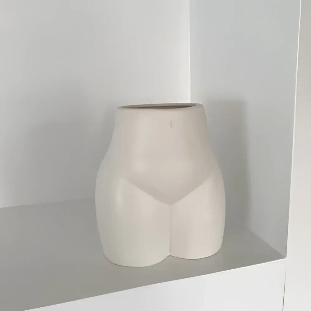 Cream-colored ceramic abstract human body vase shaped like stylized human torso for minimalist decorbites bedroom decor