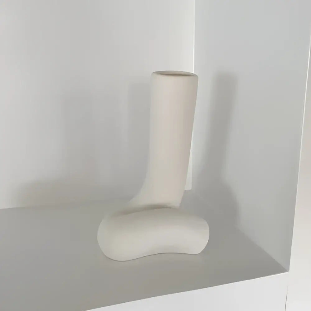 Cream-colored ceramic minimalist abstract human body vase shaped like a boot for bedroom decor by decorbites