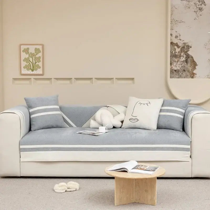 Beige skirt sofa cover with minimalist cream and beige geometric design and gray and white striped living room cushion
