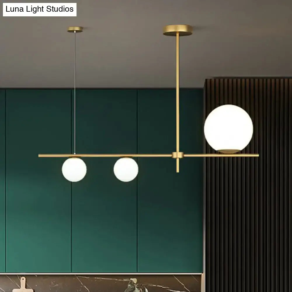 Modern brass pendant light with three cream glass globe island frosted globes for dining room lighting