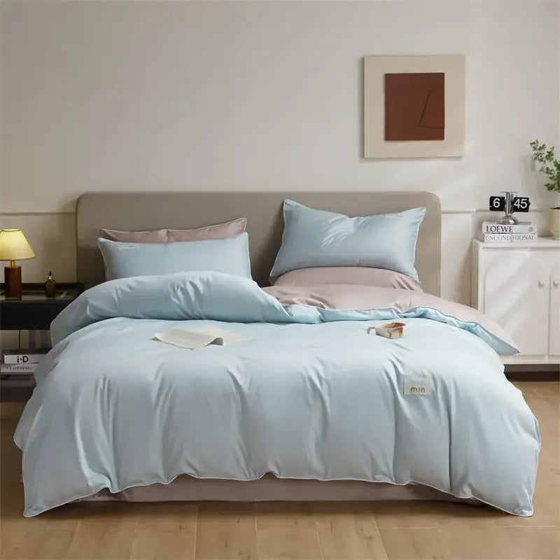 Light blue satin duvet cover set with matching pillowcases in a soft elegant design for egyptian cotton solid bedding set
