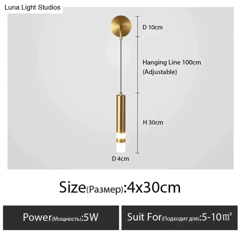 A minimalist creative luxury black and gold brass pendant light with cylindrical glass shade for luxury bedroom bedside