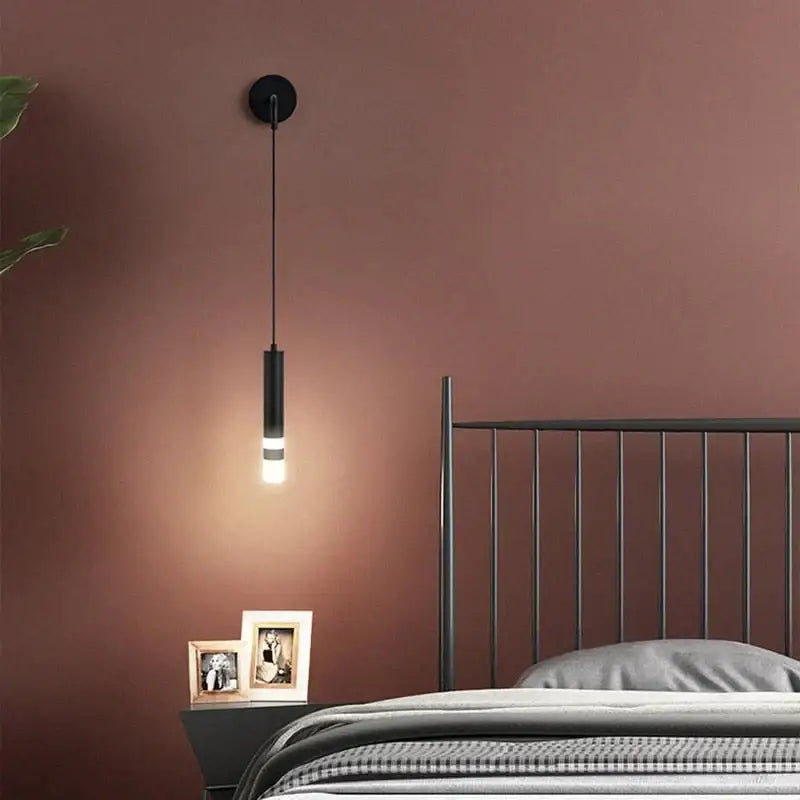 Black cylindrical minimalist creative luxury bedside wall lamp with sleek modern design for luxury bedroom use