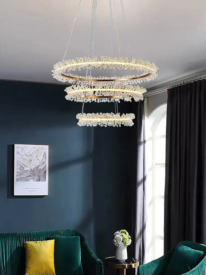 A modern multi-tiered gold black ring chandelier with crystal gold black droplets for dining room decorbites lighting