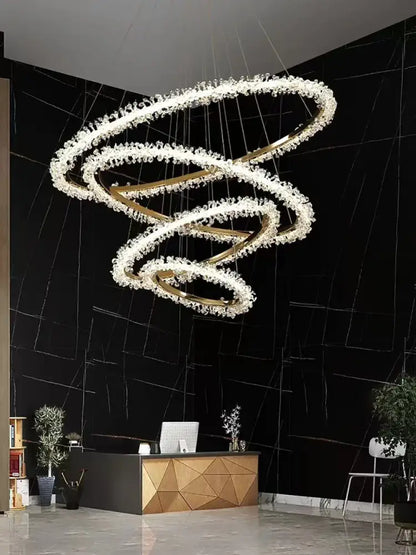 A minimalist crystal gold black ring chandelier with swirling gold rings and clear crystals for dining room decorbites decor