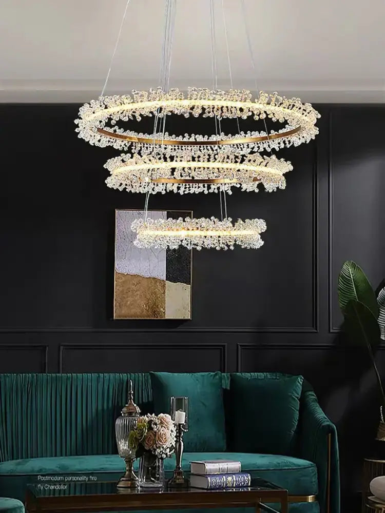 Minimalist crystal gold black ring chandelier with cascading clear crystals and gold-toned frames above dark green sofa