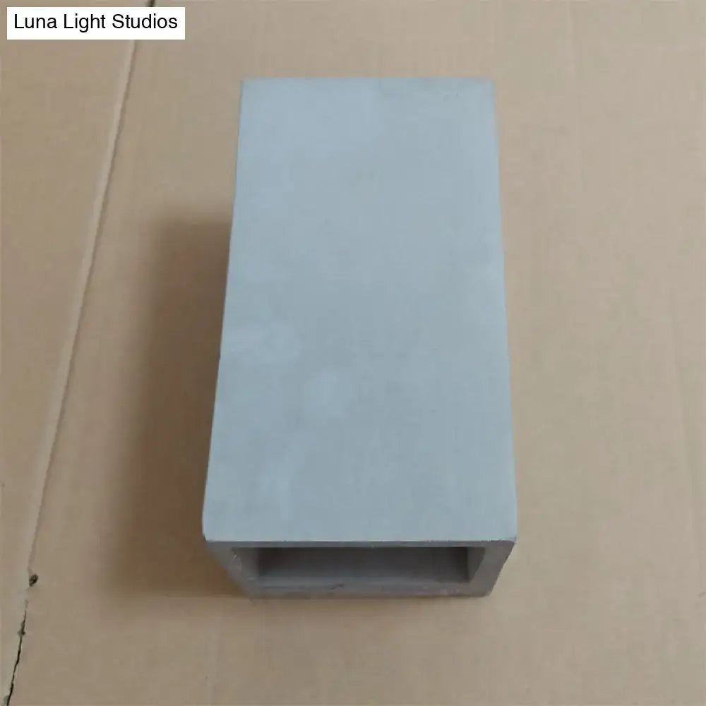 Light gray cube cuboid cement flush mount wall light with hollow center designed for minimalist stair lighting