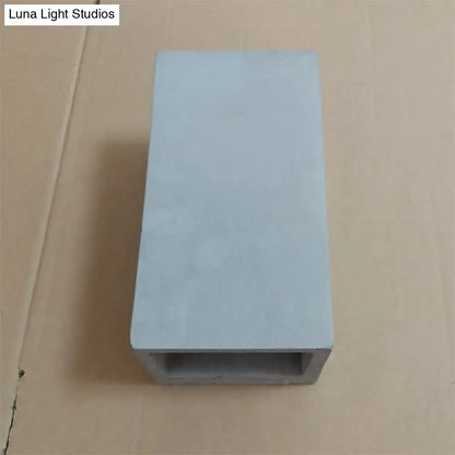 Light gray cube cuboid cement flush mount wall light with hollow center designed for minimalist stair lighting