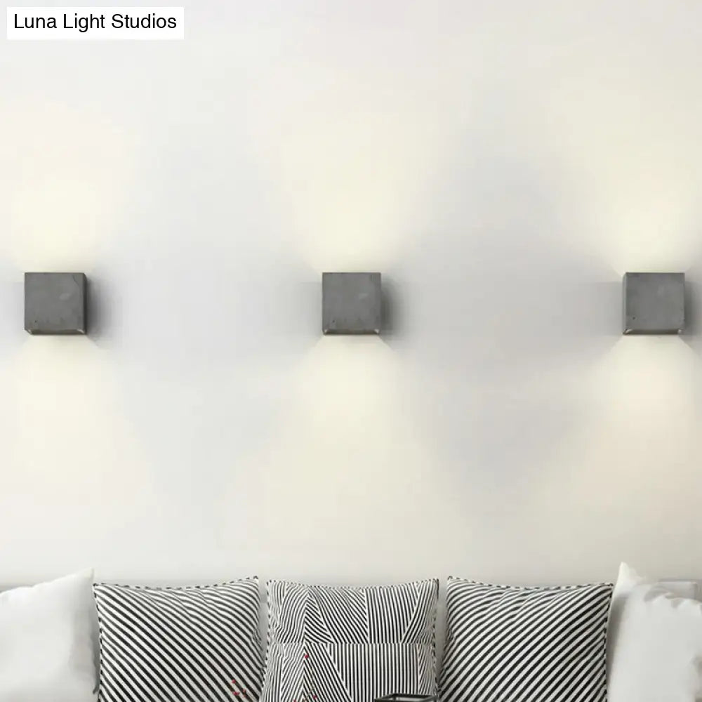 Three sleek matte gray cube cuboid cement flush mount wall light sconces for stairs with minimalist design